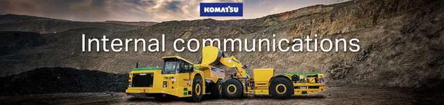 Email banner for Komatsu: “Internal communications” over a loader at a mine site.