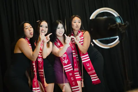 Event photo for the Multicultural Student Center: four students posing at the photo booth at the Student Achievement Gala.