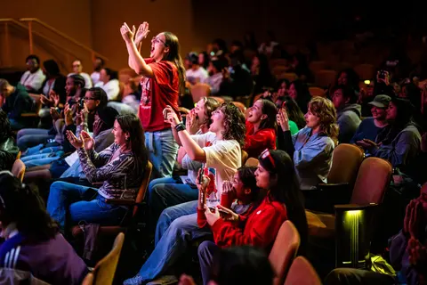 Event photo for the Multicultural Student Center: students cheering from the audience at the MCOR showcase.