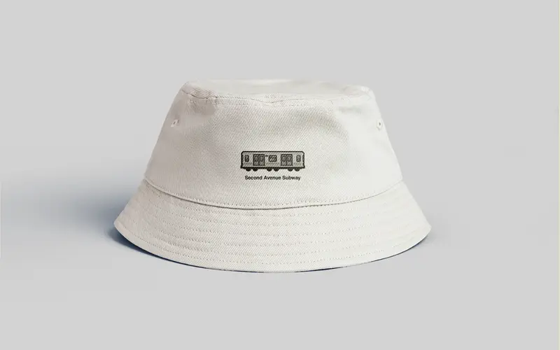 Merchandise for the Second Avenue Subway: a white bucket hat with a small train graphic.